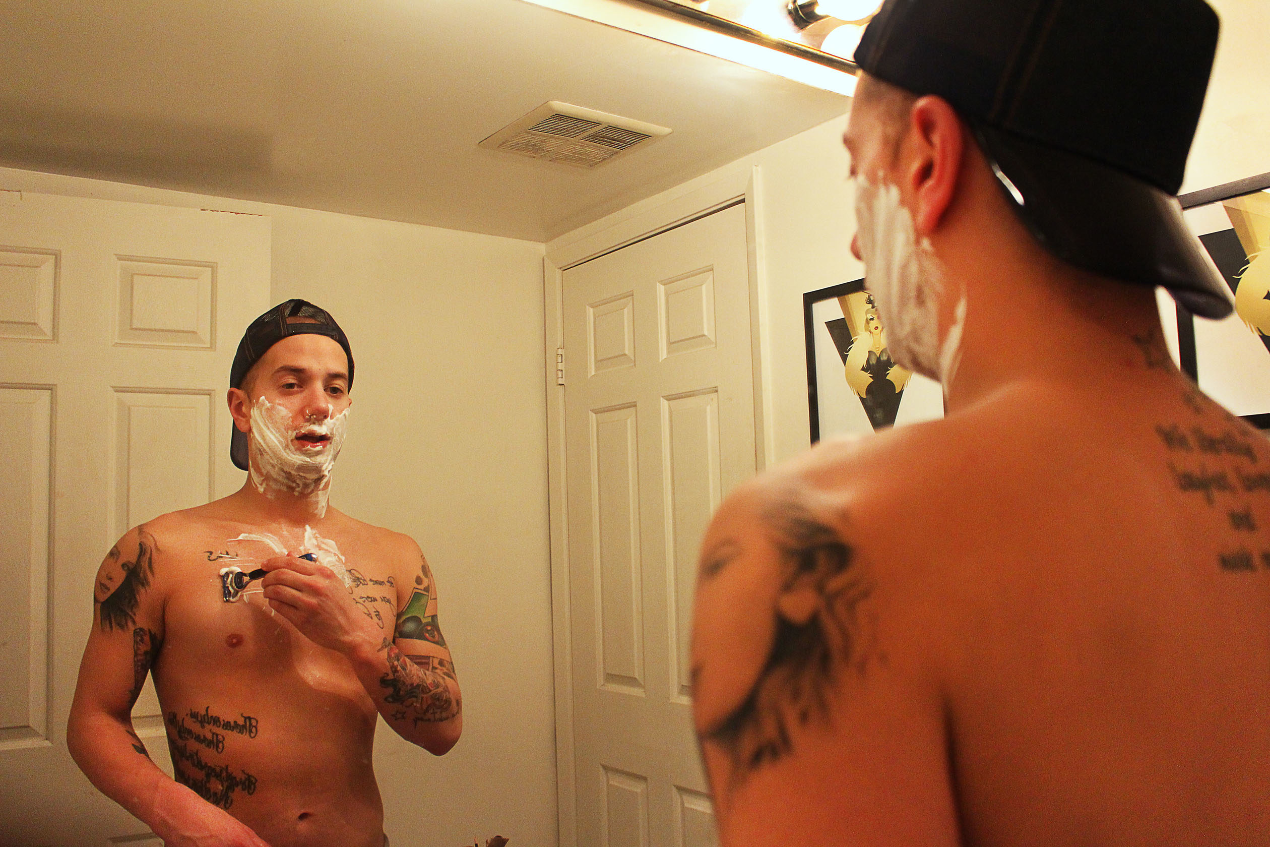 Matty Cameron looking in the mirror, shaving.